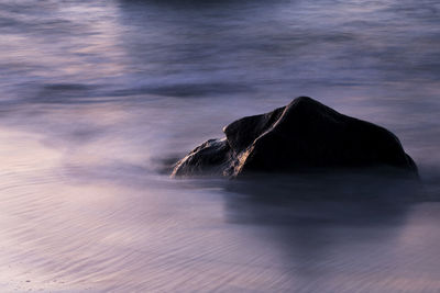 Long exposure image of rock on seashore
