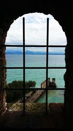 Scenic view of sea seen through arch