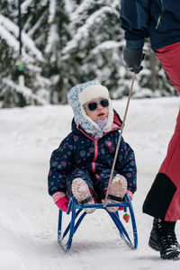 Low section of woman standing on snow