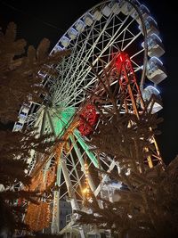 Low angle view of illuminated ferris wheel at night