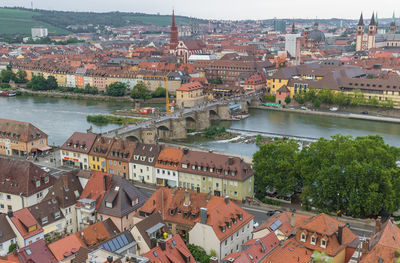 High angle view of townscape by river in city