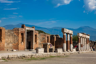 Tourists at the portico of concordia augusta on the forum of the ancient city of pompeii 