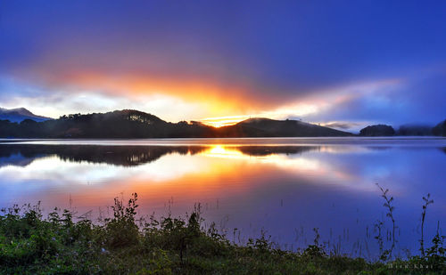 Scenic view of lake against sky during sunset