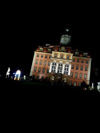 Low angle view of illuminated buildings at night