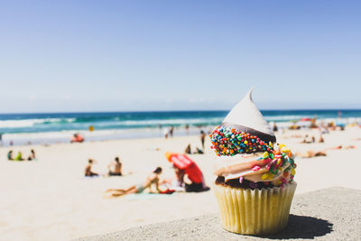 Close-up of cupcake on sunny beach
