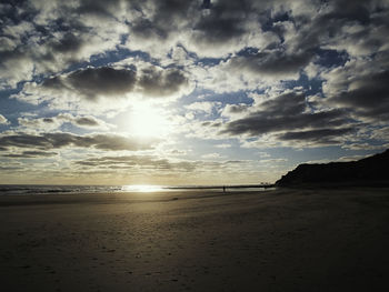 Scenic view of beach against sky during sunset