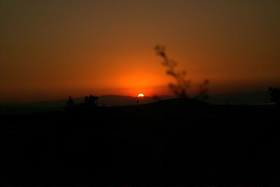 Scenic view of silhouette landscape against romantic sky at sunset