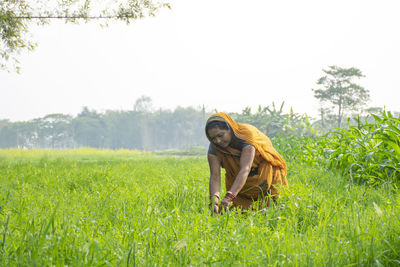 Woman wearing sari working at agricultural field in rural india