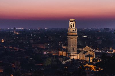 Illuminated cityscape against sky at night