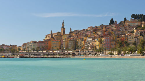 Panoramic view of sea and buildings against sky