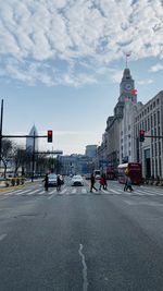 People on street against buildings in city