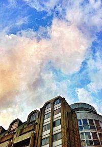 Low angle view of building against cloudy sky