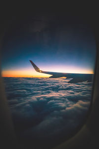 Close-up of airplane flying over sea against sky