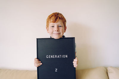 Portrait of boy against wall