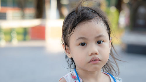 4 years old cute baby asian girl, little toddler child making frustrated face, looking camera.