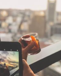 Close-up of hand holding mobile phone