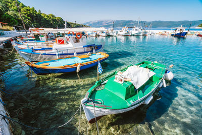 Boats moored in sea against sky