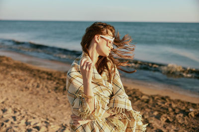 Young woman standing at beach