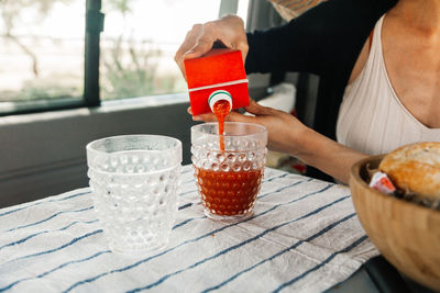 Midsection of person preparing food on table