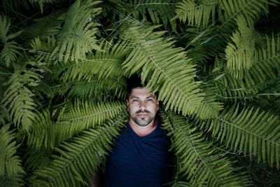 Portrait of man standing against plants