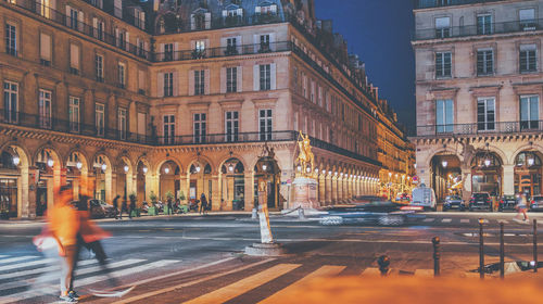 Blurred motion of people walking on street at night