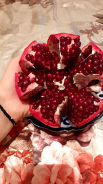 Close-up of hand holding strawberries