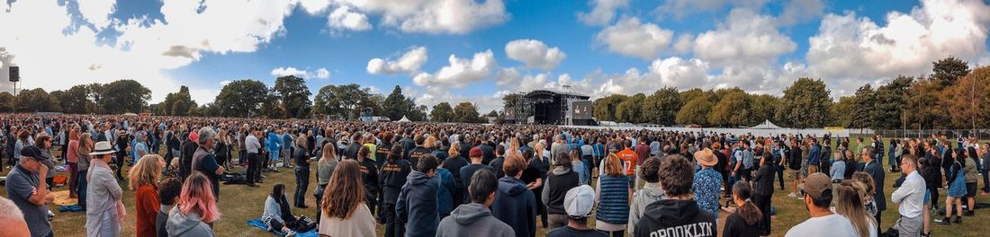 Panoramic view of group of people against sky