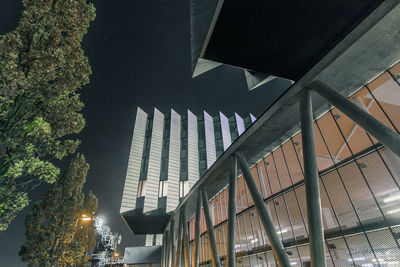 Low angle view of illuminated building against sky at night