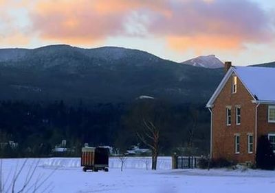 Scenic view of snow covered mountains against sky at sunset