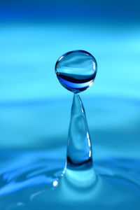 Water drop against a blue background