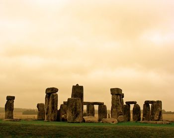 Old ruins in field against sky