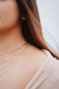 Midsection of young woman wearing necklace