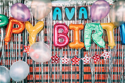 Close-up of balloons hanging in store for sale