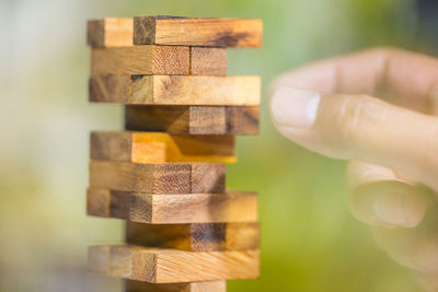 Cropped hand of man arranging toy blocks