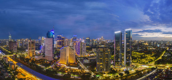 Aerial view of illuminated buildings against sky