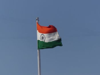 Low angle view of flag against clear sky