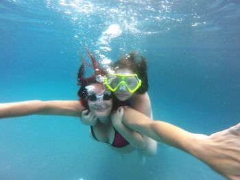 Portrait of mother and daughter swimming in sea