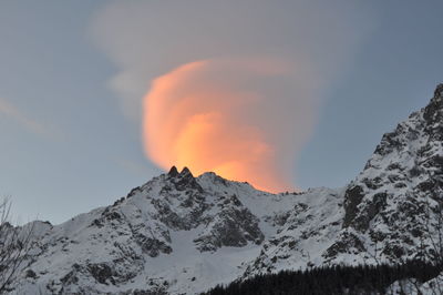 Scenic view of snowcapped mountains against sky during sunset