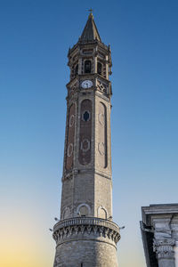 The famous pastel-shaped bell tower of lecco at sunset