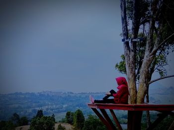 Side view of people on red looking at view