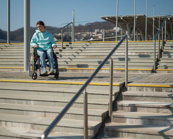 Rear view of woman walking on steps