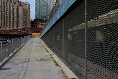 Footpath amidst buildings in city