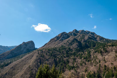 Low angle view of mountains against blue sky