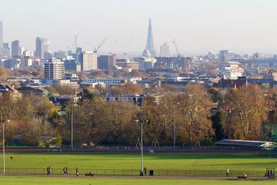 High angle view of soccer field against buildings in city