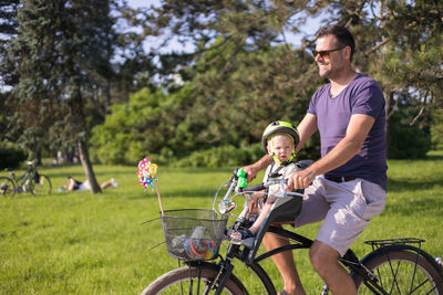 Man riding bicycle on field