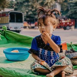 Full length of woman sitting at market stall