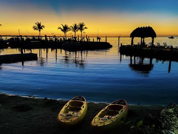 Scenic view of swimming pool by lake against sky during sunset