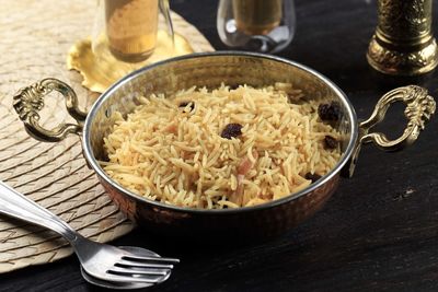 Kashmiri pulao made long grain basmati rice cooked with spices and flavored with saffron and raisin