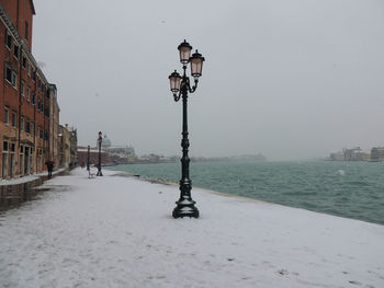 Snow storm in giudecca island, venice, with a lamp post.