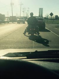 Man on road against sky in city